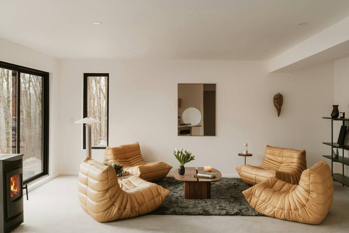 Side-by-side comparison: flat canvas vs. 3D layered wood wall art in a modern living room with oak flooring and linen curtains